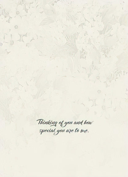 The interior of the "FAITH HOPE LOVE" card with a subtle textured background and the message "Thinking of you and how special you are to me."