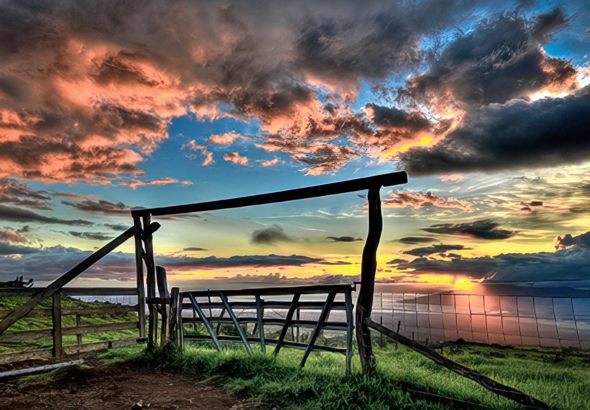 Scenic landscape greeting card featuring a rustic wooden gate and fence at sunset, vibrant orange and blue clouds, and a calm ocean vista, perfect for thoughtful messages.