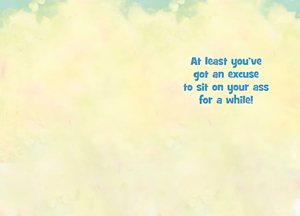 Inside view of a funny get well card with a light yellow background and the text 'At least you've got an excuse to sit on your ass for a while!' in blue lettering, offering a cheeky message for recovery.