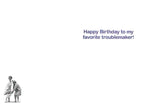 Inside of a funny greeting card with purple text 'Happy Birthday to my favorite troublemaker!' and a small image of two mischievous older women, ideal for a humorous friend's card.
