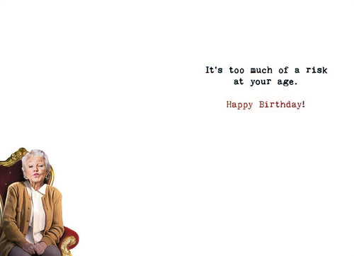 Inside of a humorous senior birthday card for grandparents, revealing the witty punchline: 'It's too much of a risk at your age. Happy Birthday!', with a partial view of the old woman from the front.