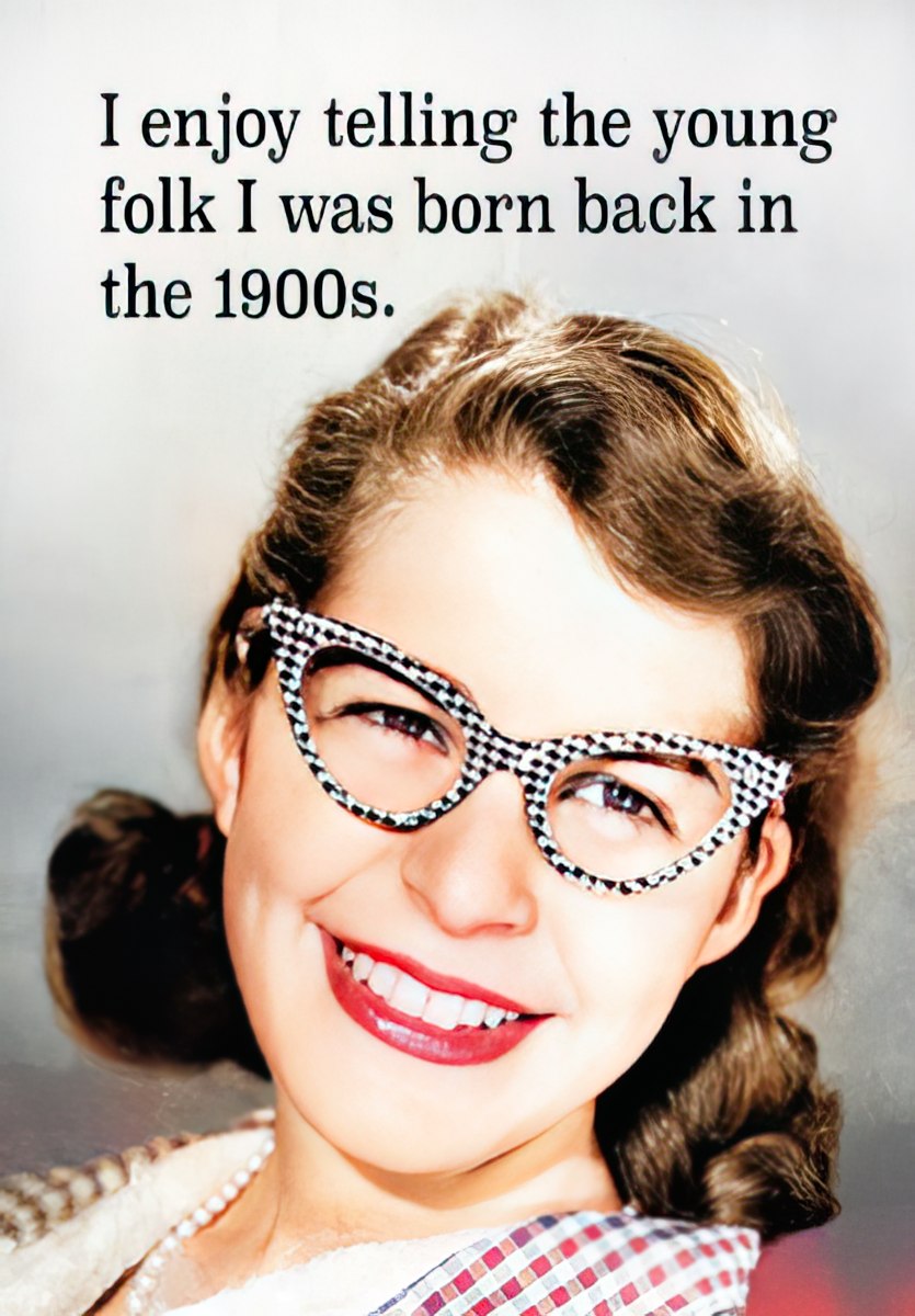 Front of a humorous greeting card featuring a smiling woman with retro cat-eye glasses, text reads: "I enjoy telling the young folk I was born back in the 1900s." Perfect for funny cards for older recipients celebrating their birthday.