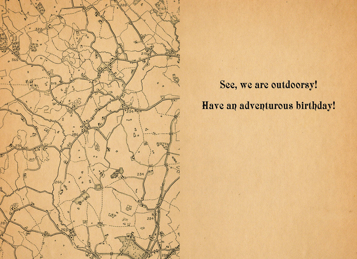 Inside of a humorous greeting card showing an antique map on the left and text 'See, we are outdoorsy! Have an adventurous birthday!' on the right, suitable for a lighthearted celebration.