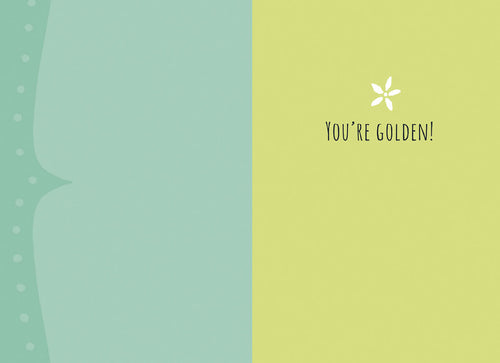 The open inside of a friendship greeting card. The left panel is light teal. The right panel is light yellow-green with a white starburst and the text 'YOU'RE GOLDEN!' in black, ready for a complimentary message.