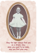 Front of vintage encouragement greeting card featuring a sepia-toned photo of a smiling red-headed girl in an oval frame, set against a delicate lace background. The card reads: "May the light always find you on a dreary day; when you need to be home, may you find your way."