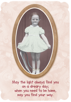 Front of vintage encouragement greeting card featuring a sepia-toned photo of a smiling red-headed girl in an oval frame, set against a delicate lace background. The card reads: "May the light always find you on a dreary day; when you need to be home, may you find your way."