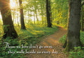 Sun-drenched forest path at sunrise with a comforting quote, 'Those we love don't go away, they walk beside us every day...' a heartfelt bereavement greeting card.