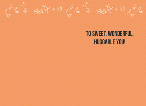 Inside view of a cute Halloween card with a warm orange background, adorned with delicate white star and leaf illustrations, and the heartfelt message 'TO SWEET, WONDERFUL, HUGGABLE YOU!' in dark lettering, ideal for a child.