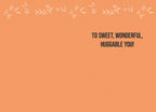 Inside of a friendly greeting card featuring a simple orange background with white leaf accents and the message 'TO SWEET, WONDERFUL, HUGGABLE YOU!' in bold black text.