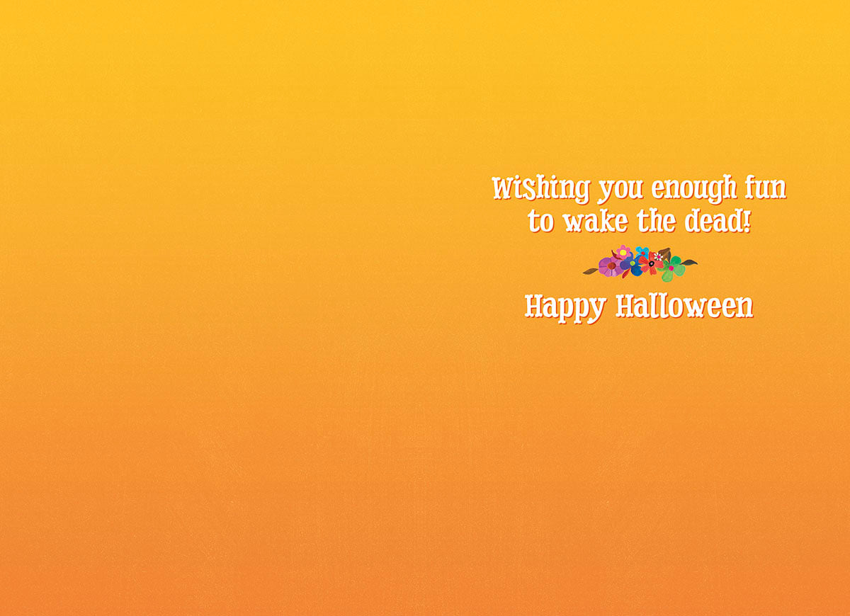 Inside of a humorous greeting card featuring an orange background with the text 'Wishing you enough fun to wake the dead! Happy Halloween' and small floral illustration.