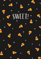 Close-up of a festive greeting card with a black background, featuring a playful pattern of orange, yellow, and white candy corn pieces and small grey stars. The word 'SWEET!' is prominently displayed in the center in a friendly, light gray font, perfect for a joyful autumn celebration.