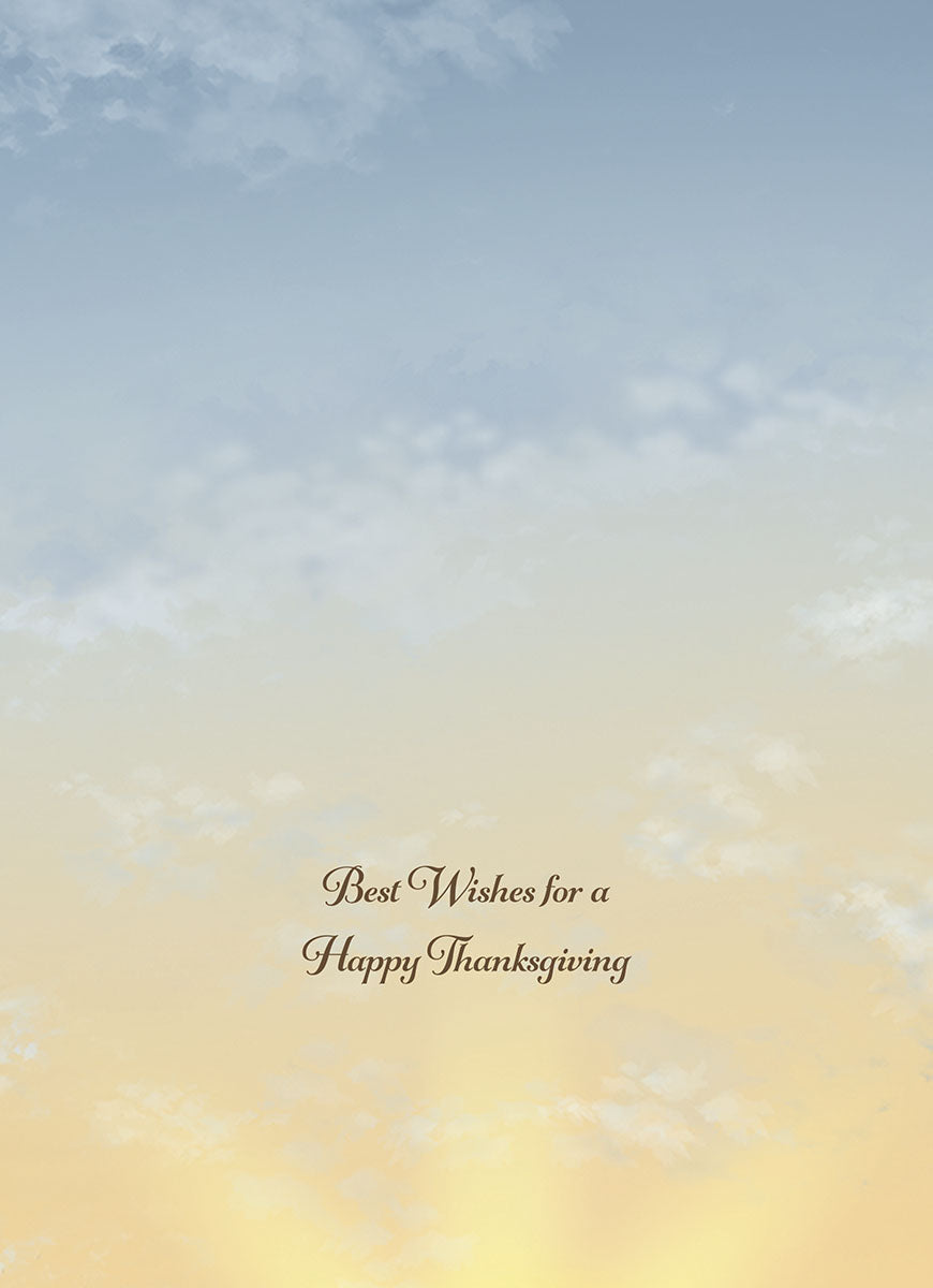 Inside of an autumn greeting card showing a serene blue and yellow sky with text 'Best Wishes for a Happy Thanksgiving'.