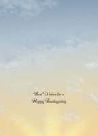 Inside of an autumn greeting card showing a serene blue and yellow sky with text 'Best Wishes for a Happy Thanksgiving'.