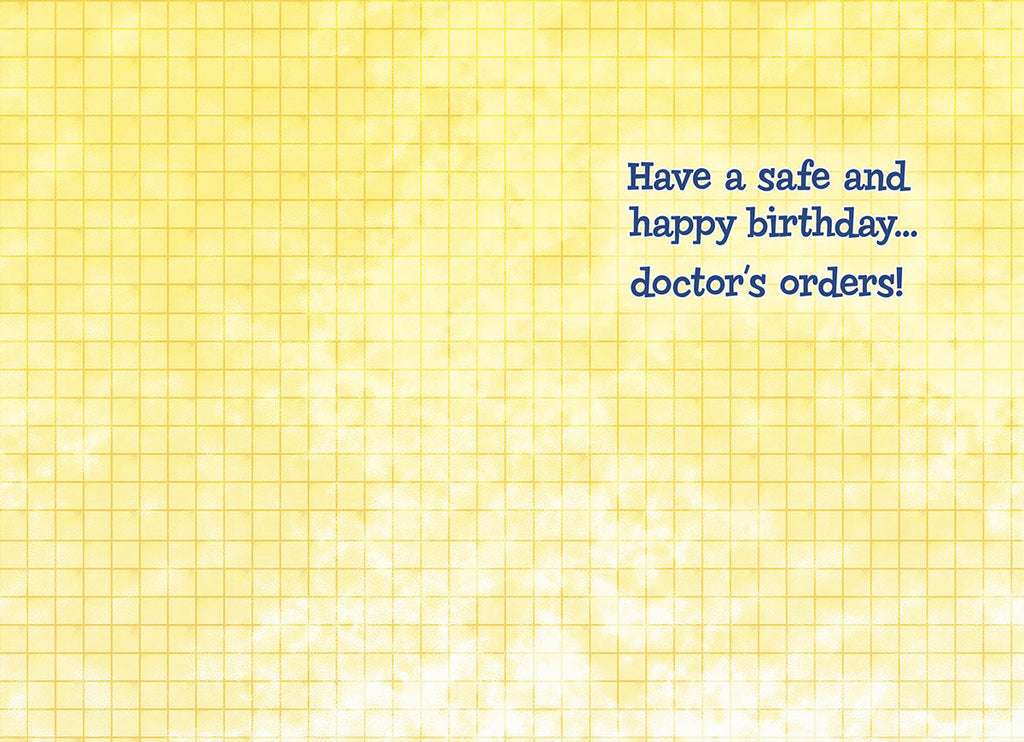 Inside view of a humorous birthday card with a yellow grid pattern background, displaying the message 'Have a safe and happy birthday... doctor's orders!'