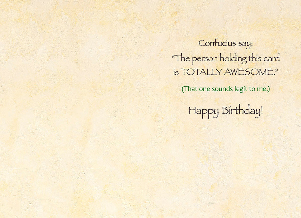 Inside view of a funny birthday card, revealing an inner message 'Confucius say: The person holding this card is TOTALLY AWESOME.' followed by '(That one sounds legit to me.) Happy Birthday!' against a textured, light cream background.