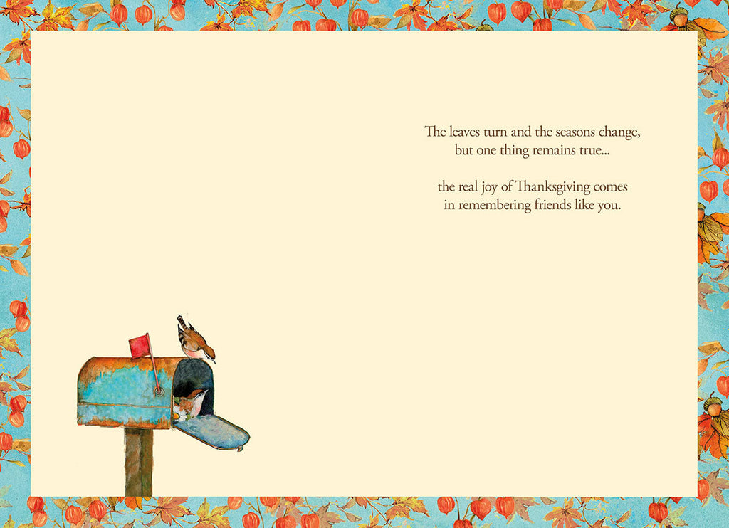 Inside view of a heartfelt Thanksgiving greeting card with a cream background and a decorative border of autumn leaves and Chinese lanterns. The message reads: 'The leaves turn and the seasons change, but one thing remains true... the real joy of Thanksgiving comes in remembering friends like you.' A small bird and mailbox illustration appears at the bottom left.