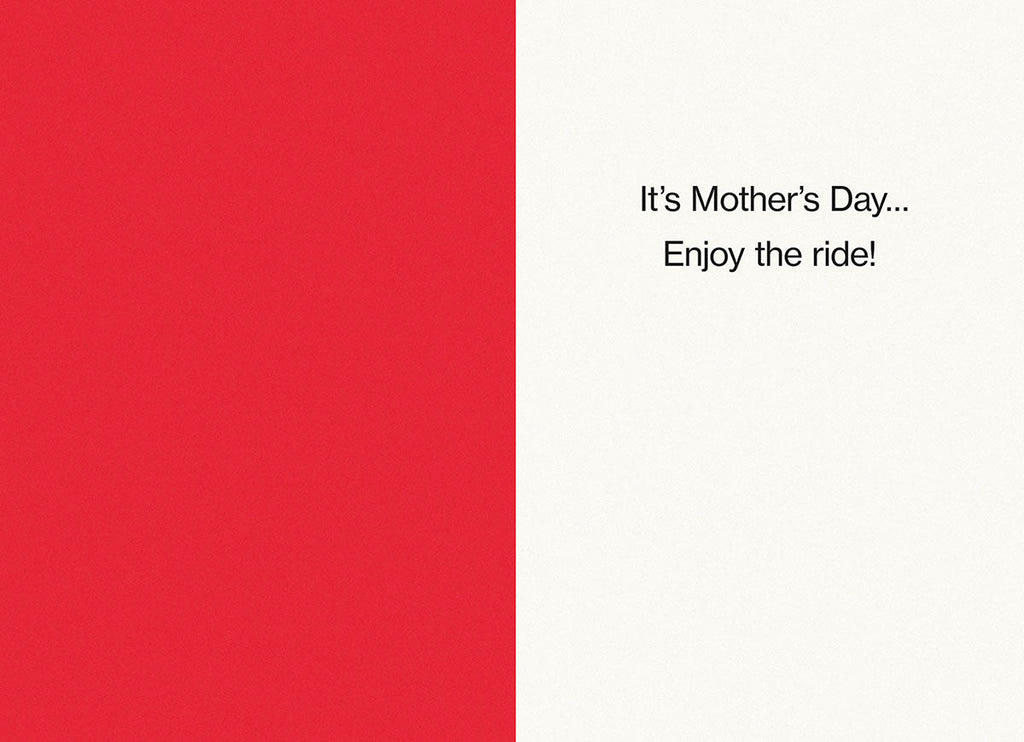 Inside view of a funny Mother's Day card, red on one side and white on the other, with the lighthearted message 'It's Mother's Day... Enjoy the ride!'