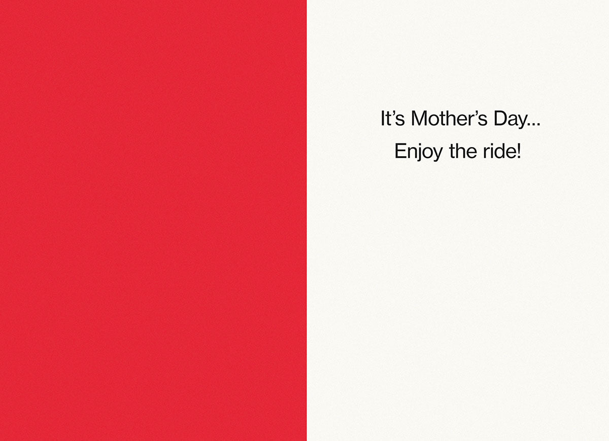 Inside view of a funny Mother's Day card, red on one side and white on the other, with the lighthearted message 'It's Mother's Day... Enjoy the ride!'