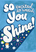 Front of a vibrant blue graduation card with white bold text 'So excited to watch You Shine!' surrounded by colorful stars and sparkling designs, perfect for celebrating academic achievement.