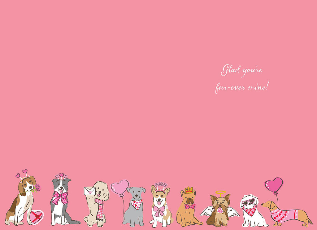 Inside of a romantic greeting card with a soft pink background. A row of cartoon dogs, dressed in Valentine's Day accessories like heart bows and crowns, lines the bottom. Elegant cursive text reads 'Glad you're fur-ever mine!'.