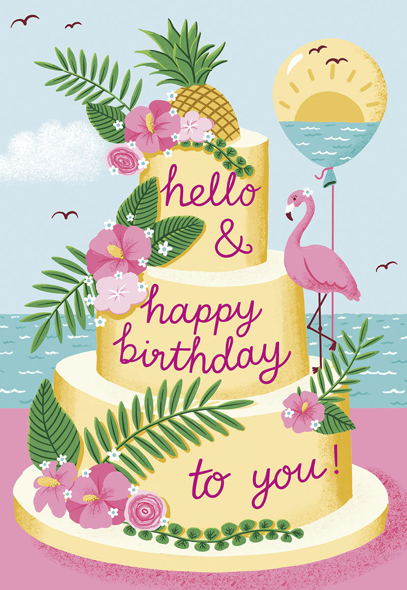 Vibrant tropical birthday greeting card featuring a three-tier cake with pineapple, hibiscus, palm leaves, and a pink flamingo holding an ocean sunset balloon. Front reads 'hello & happy birthday to you!'