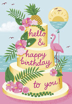 Vibrant tropical birthday greeting card featuring a three-tier cake with pineapple, hibiscus, palm leaves, and a pink flamingo holding an ocean sunset balloon. Front reads 'hello & happy birthday to you!'