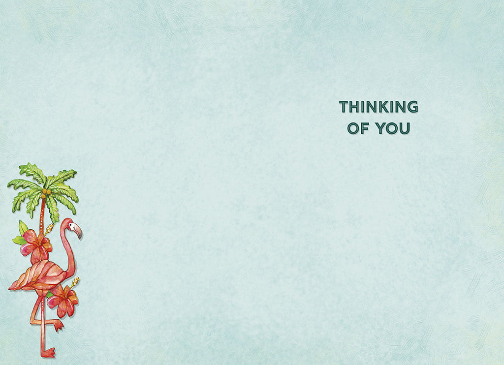 Inside of a lighthearted greeting card showing a small flamingo and palm tree illustration, with the heartfelt message 'THINKING OF YOU' printed on a soft blue background.