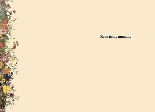 Inside of an encouraging greeting card with a delicate floral border and the heartfelt message 'Keep being amazing!' against a cream background.