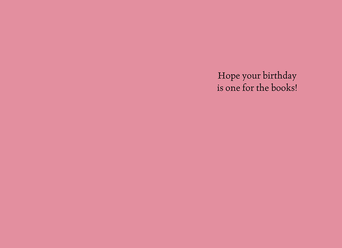 The inside of a funny birthday greeting card for her, showing a solid light pink background with elegant black text that reads: 'Hope your birthday is one for the books!'