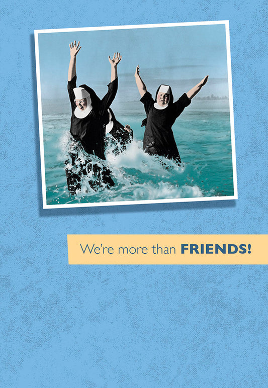 Two joyful nuns in full habits splashing and laughing in the ocean waves, arms raised in excitement, with the text 'We're more than FRIENDS!' below.