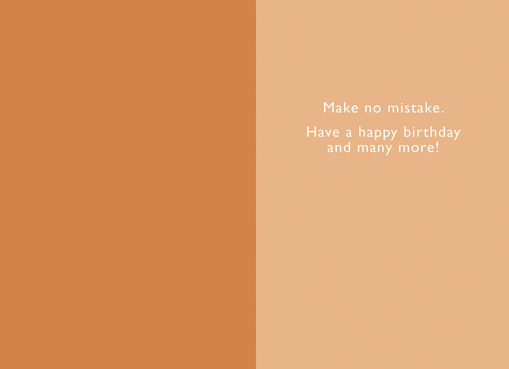 Inside of a lighthearted card, displaying the warm message 'Make no mistake. Have a happy birthday and many more!' on a warm orange and cream background.