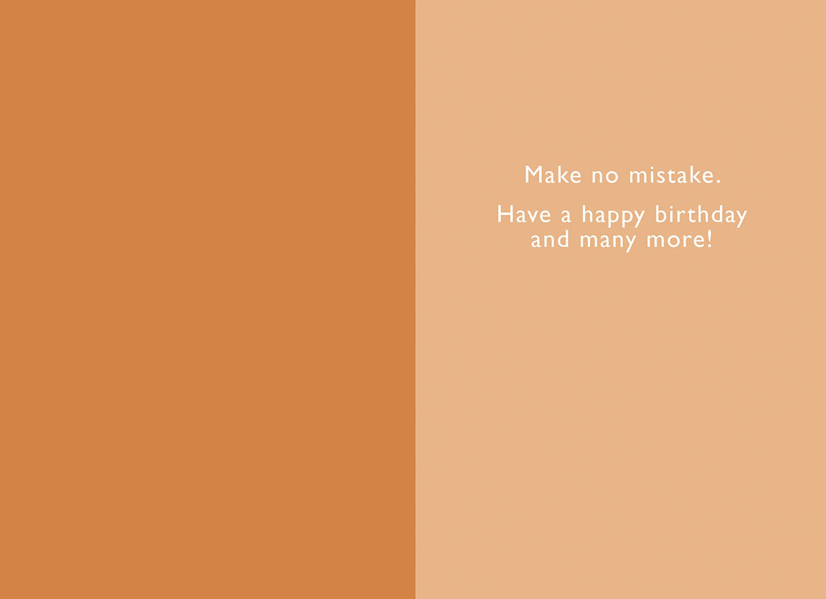 Inside of a lighthearted card, displaying the warm message 'Make no mistake. Have a happy birthday and many more!' on a warm orange and cream background.