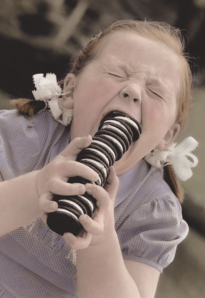 Close-up of a joyful child with pigtails excitedly eating a tall stack of chocolate cream cookies, capturing a moment of pure sugary delight. Perfect for a kids' special day card.