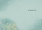 Inside of a greeting card with a light teal background and subtle watercolor floral elements in the bottom left corner. The message 'YOU MADE MY DAY!' is printed in a casual font on the right side.