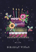 Elegant tiered birthday cake greeting card with lit candles, colorful flowers, vibrant butterflies, and golden glitter stars on a dark navy background, perfect for wishing anyone a joyous celebration.