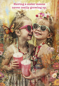 Front of a lighthearted birthday greeting card for a sister, featuring two laughing young girls in pink sunglasses holding pink drinks, surrounded by vibrant flowers and a butterfly, with the text 'Having a sister means never really growing up.'