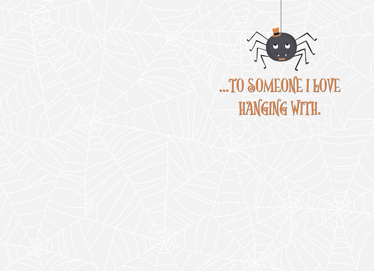 Inside of a cute Halloween greeting card with a small spider and text 'TO SOMEONE I LOVE HANGING WITH.' on a subtle spiderweb background.