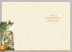 Inside view of a cream-colored Halloween greeting card with subtle damask patterns. The left edge reveals a partial design of a succulent bouquet, skulls in a cloche, and a pumpkin. The right side features a lighthearted message in gold: 'HAVE A HAUNTINGLY GOOD TIME!'