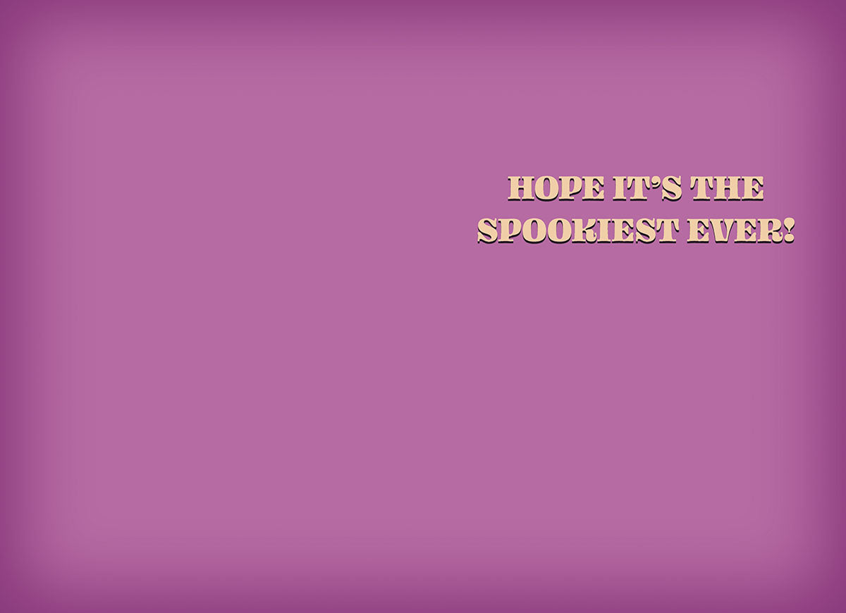 Inside of a cute greeting card featuring a simple purple background with the playful message 'HOPE IT'S THE SPOOKIEST EVER!' in bold orange text.