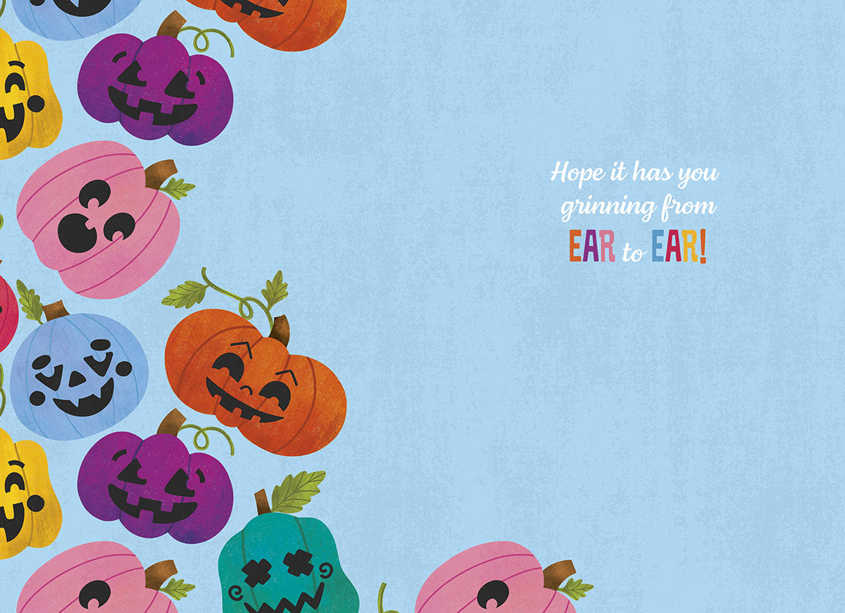 Inside view of a cheerful Halloween greeting card with an array of smiling, colorful pumpkins bordering a light blue background, featuring the message 'Hope it has you grinning from EAR to EAR!'.