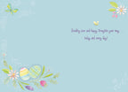 Inside of a thoughtful Easter card with a light blue background, displaying the heartfelt message 'Sending love and happy thoughts your way... today and every day!' alongside decorative watercolor eggs and floral accents.