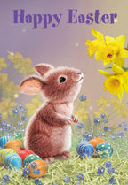 Cute brown bunny looking at yellow daffodils with colorful patterned eggs in spring grass, ideal for an Easter greeting card for kids.