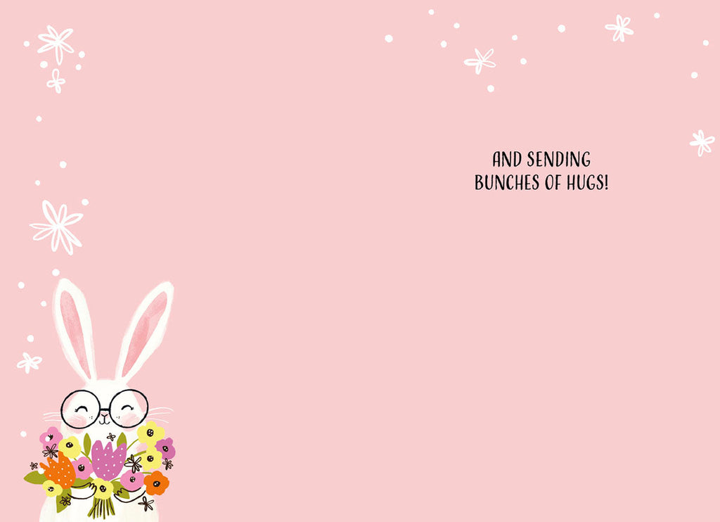 Inside of an Easter card featuring a cute bunny and colorful flowers in the bottom left, with 'AND SENDING BUNCHES OF HUGS!' on a soft pink background. Perfect for sending warm wishes to children.