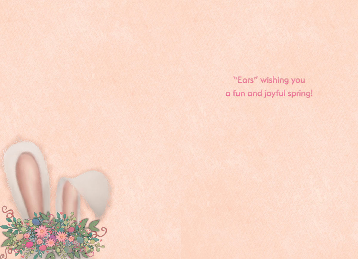 Inside of a light peach colored greeting card with a small illustration of white bunny ears with a floral and egg bouquet in the bottom left corner. The right side of the card features the sweet, punny message: '"Ears" wishing you a fun and joyful spring!'.