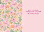 Inside of a cheerful floral greeting card with a painterly pattern of pink, yellow, and green flowers on a light pink background, featuring the uplifting message 'MAY YOU FIND SWEETNESS AND JOY IN EVERYTHING!' on the right panel.