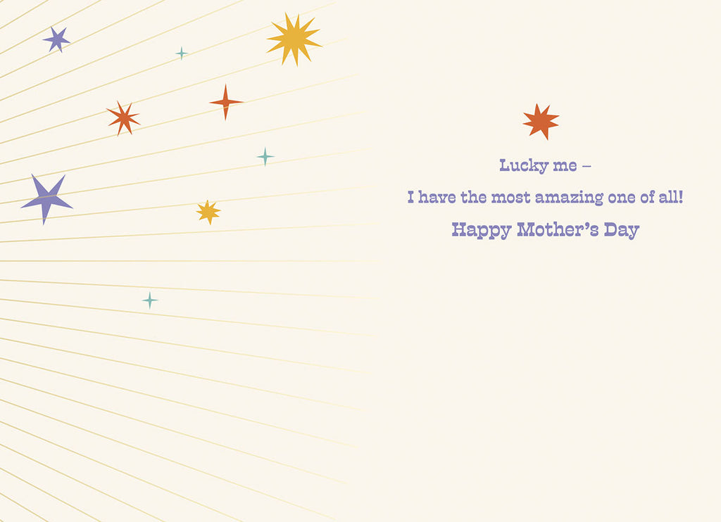 Inside of a Mother's Day greeting card with a light background and subtle starburst design. Text reads "Lucky me - I have the most amazing one of all! Happy Mother's Day" in an elegant purple font, surrounded by small colorful stars.