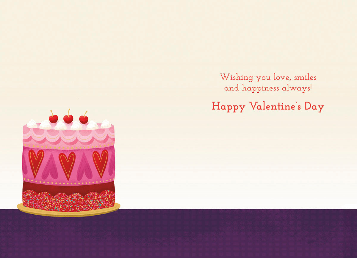 Open romantic Valentine's Day greeting card, showing the cake illustration on the left and a printed message on the right: 'Wishing you love, smiles and happiness always! Happy Valentine's Day'.