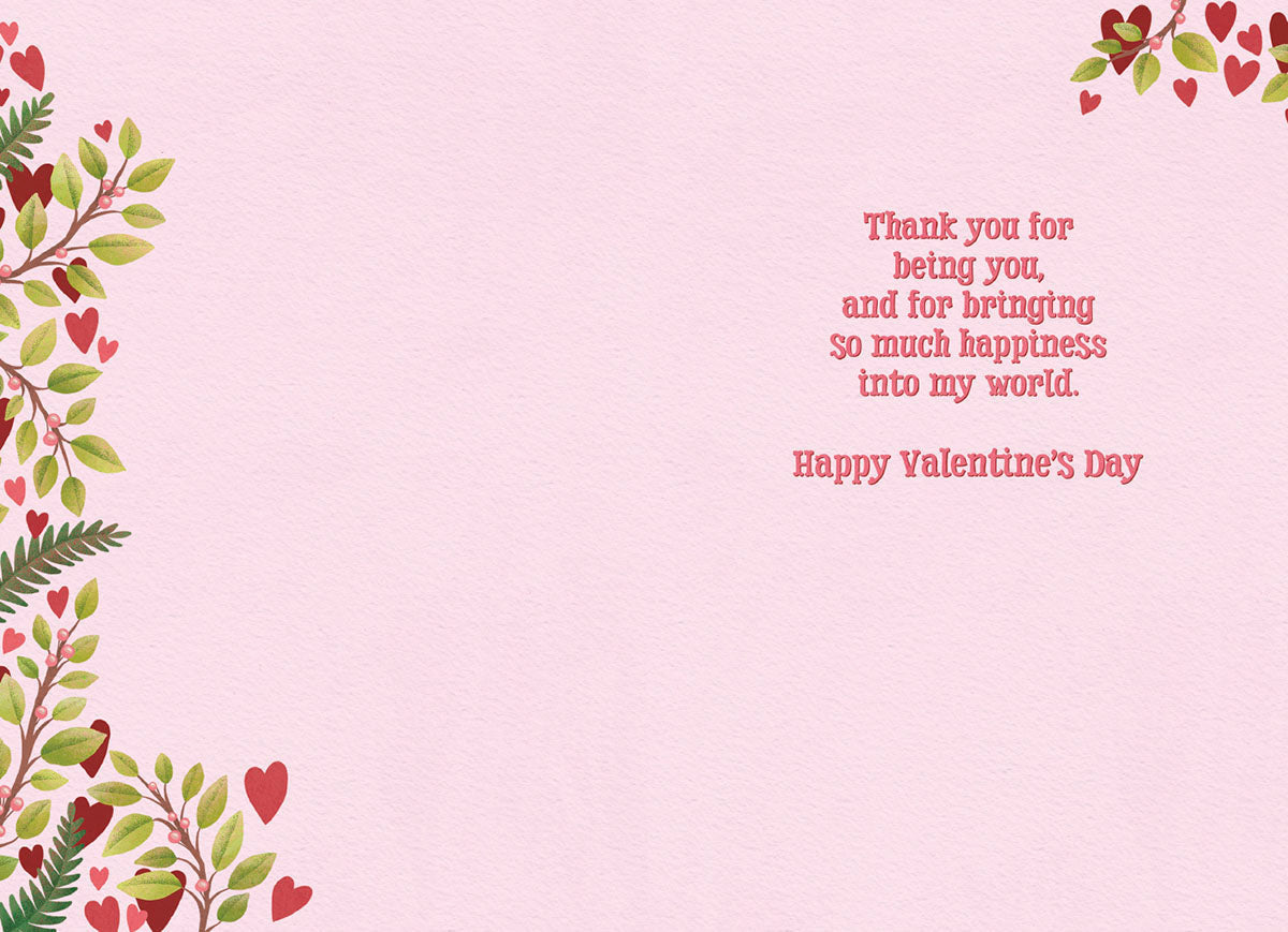 Inside of a romantic Valentine's Day greeting card with a light pink textured background. The right side displays the message 'Thank you for being you, and for bringing so much happiness into my world. Happy Valentine's Day' in elegant red script. Green leafy branches with red hearts and berries adorn the left side and top edge.
