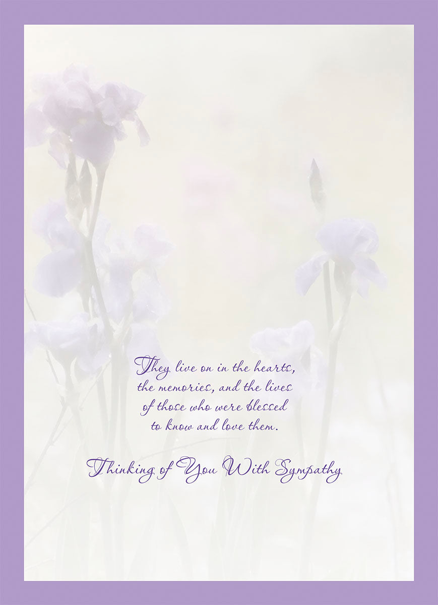 Inside view of a heartfelt sympathy card, showing a gentle floral design with muted purple irises and the message 'They live on in the hearts, the memories, and the lives of those who were blessed to know and love them. Thinking of You With Sympathy.'.