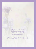Inside view of a heartfelt sympathy card, showing a gentle floral design with muted purple irises and the message 'They live on in the hearts, the memories, and the lives of those who were blessed to know and love them. Thinking of You With Sympathy.'.